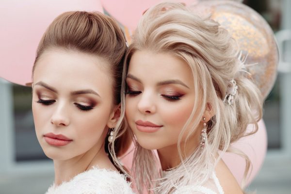 Two gorgeous models with make up and hairdo in white